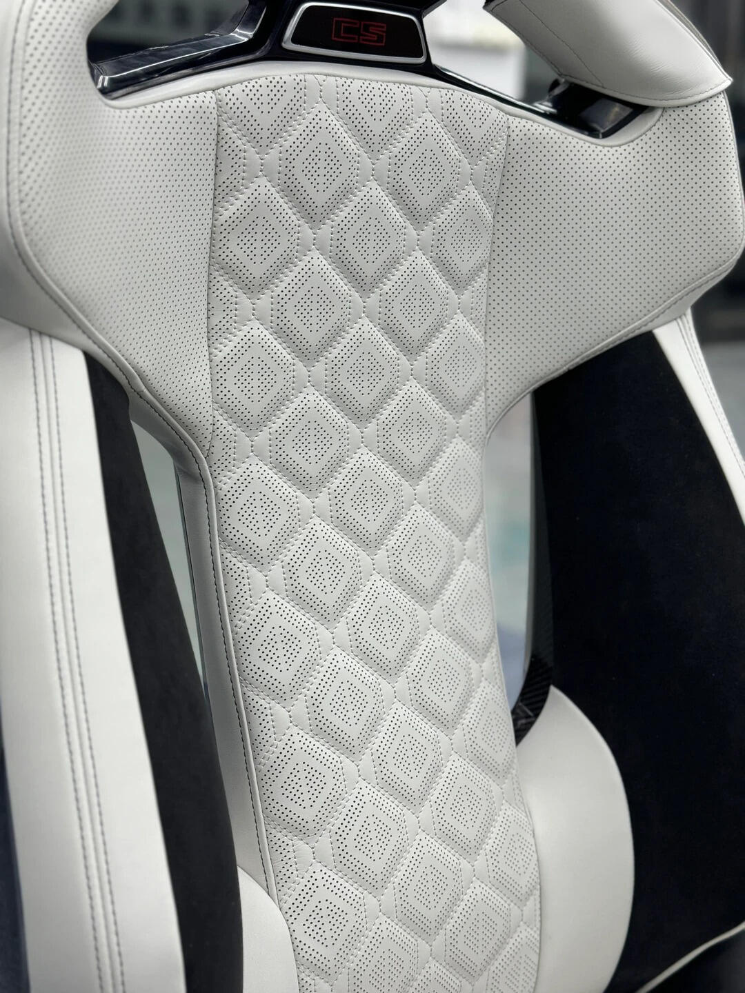 BMW M Carbon Fiber Bucket Seat backrest with illuminated headrest emblem and M8-style diamond quilted leather