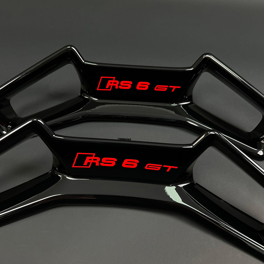 Audi RS6 GT headrest trim panel pair – gloss black with RS6 GT badge in red, RS and RS6 GT variants side by side
