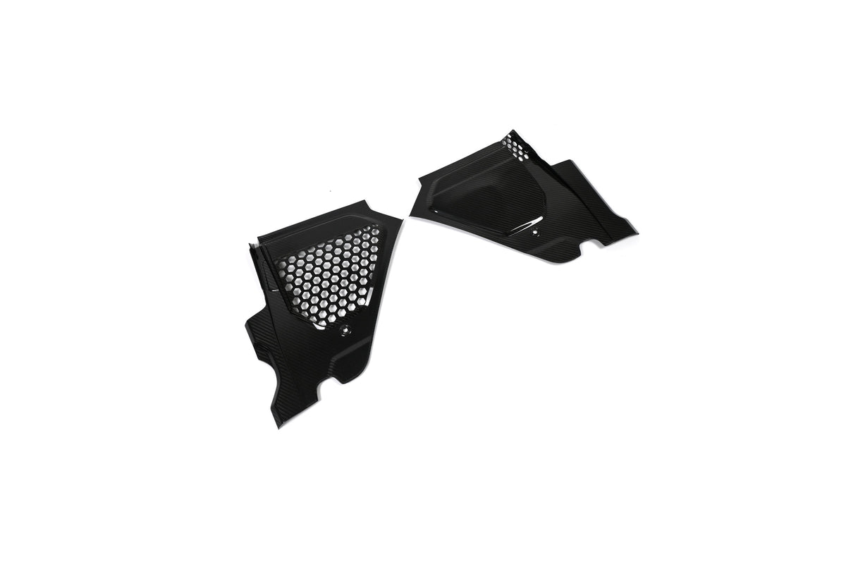 BMW G22 4 Series carbon fiber engine bay corner panels are angled on white with the mesh panel nearer the front.
