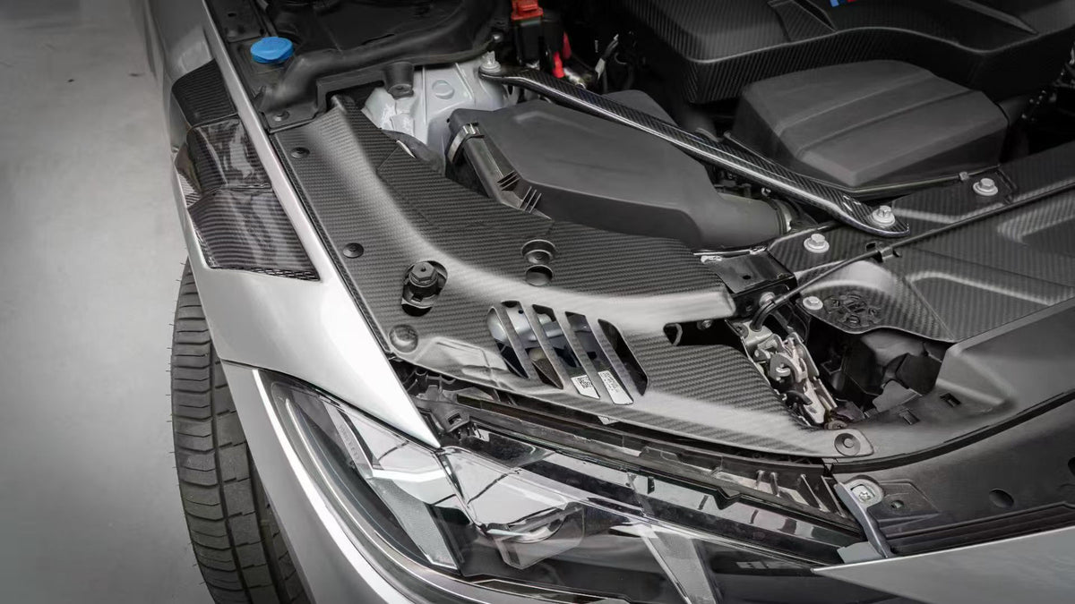 BMW G22 4 Series carbon fiber headlight cover panels are shown above a silver car's headlight with slots visible.