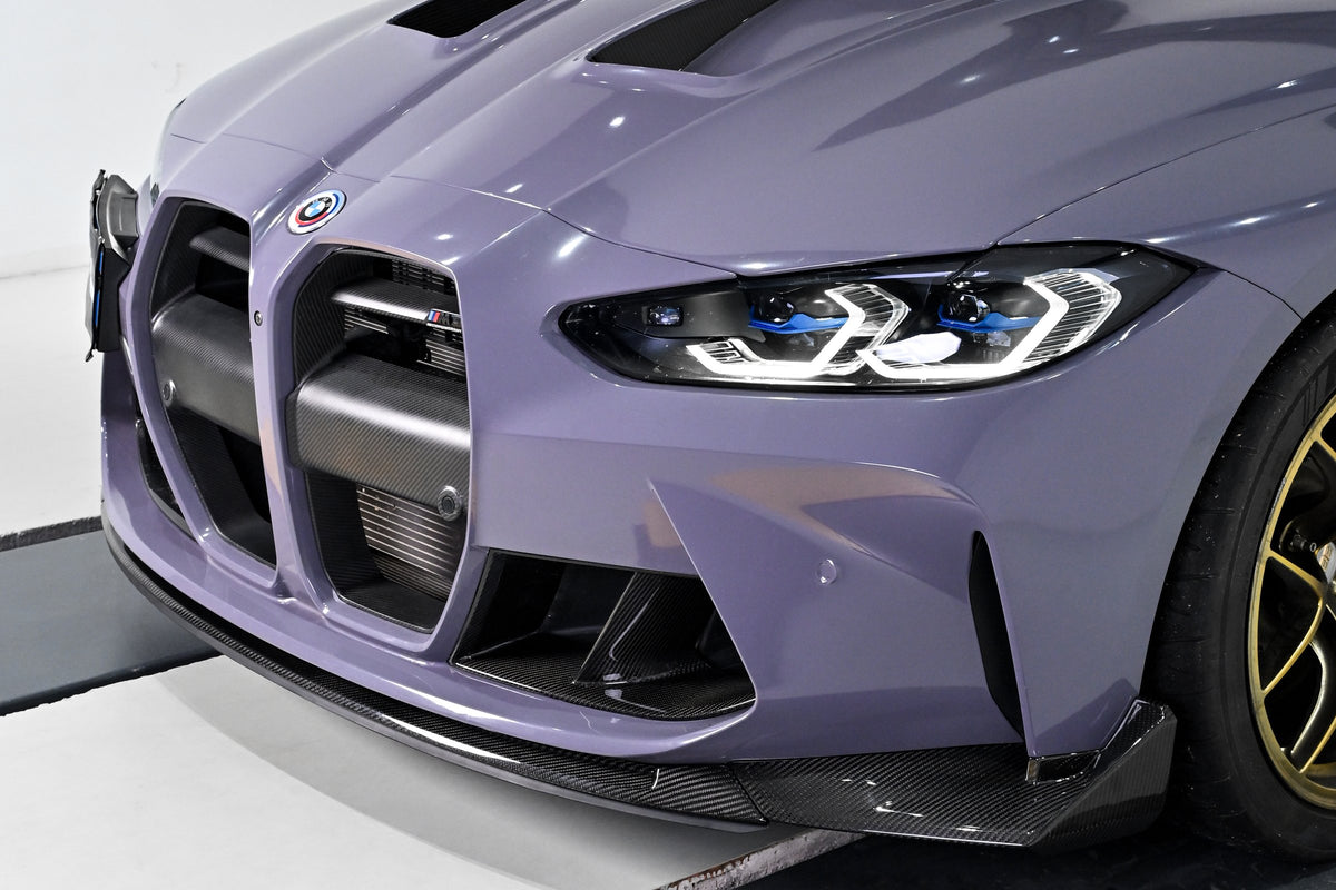 Three-quarter view of a BMW G82 M4 with the CSL style carbon fiber front lip