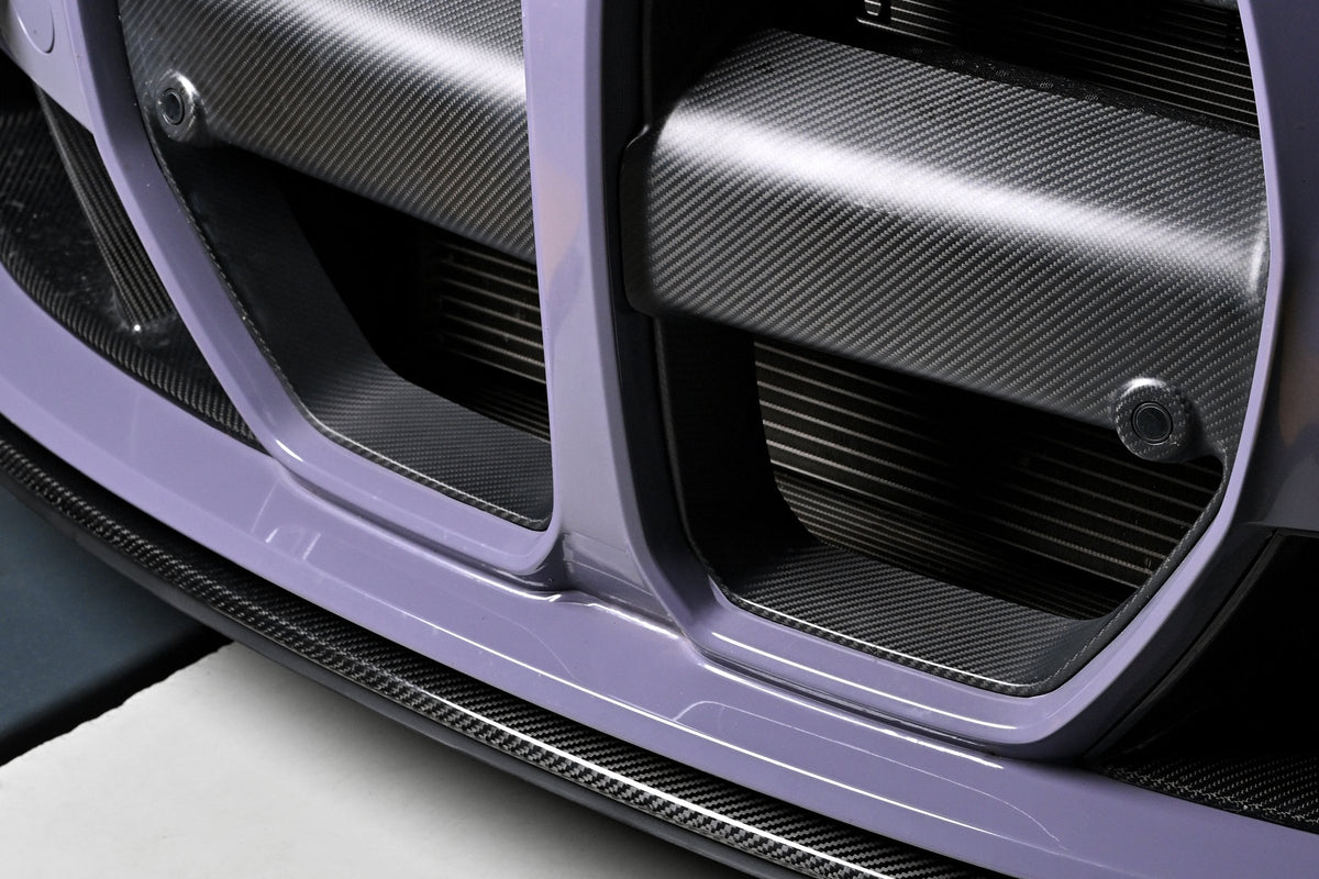 CSL style carbon fiber front lip below the kidney grille of a BMW G82 M4