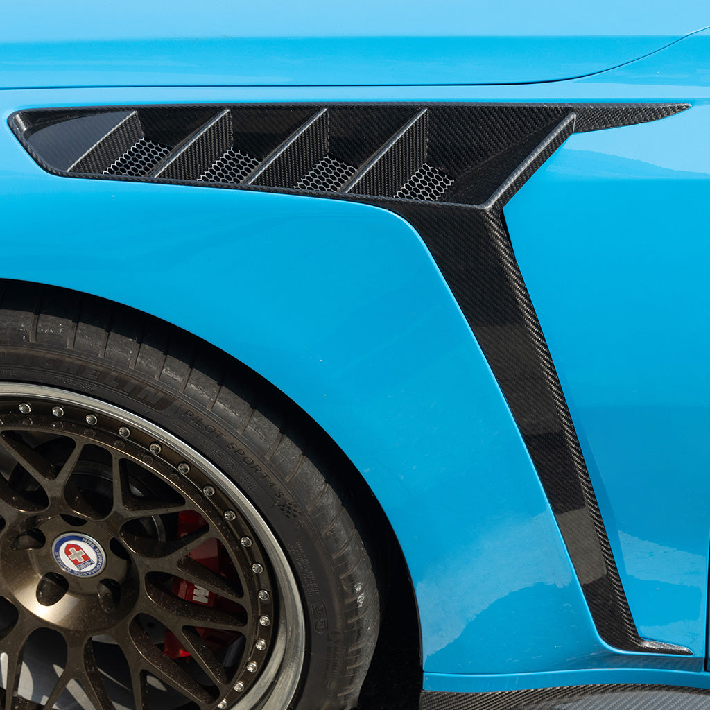 BMW G80 M3 G82 M4 SQ style front fender side vent close-up on blue G80 M3