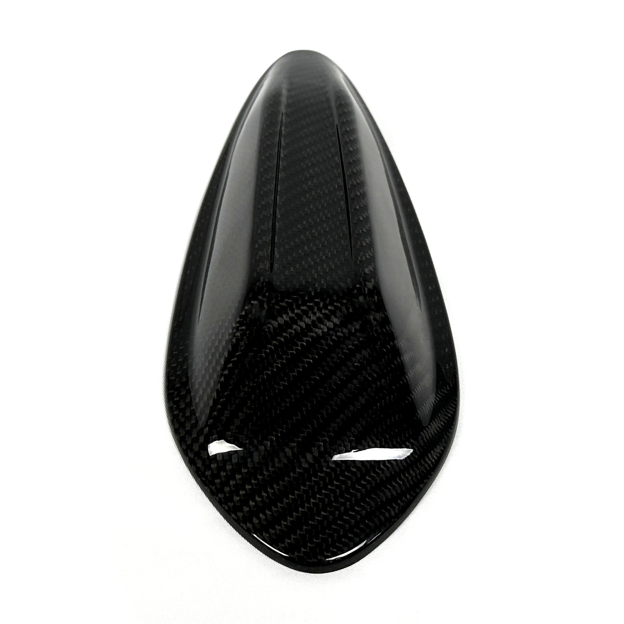 Top down view of the BMW G8X carbon fiber roof antenna cover, weave running the length of the fin
