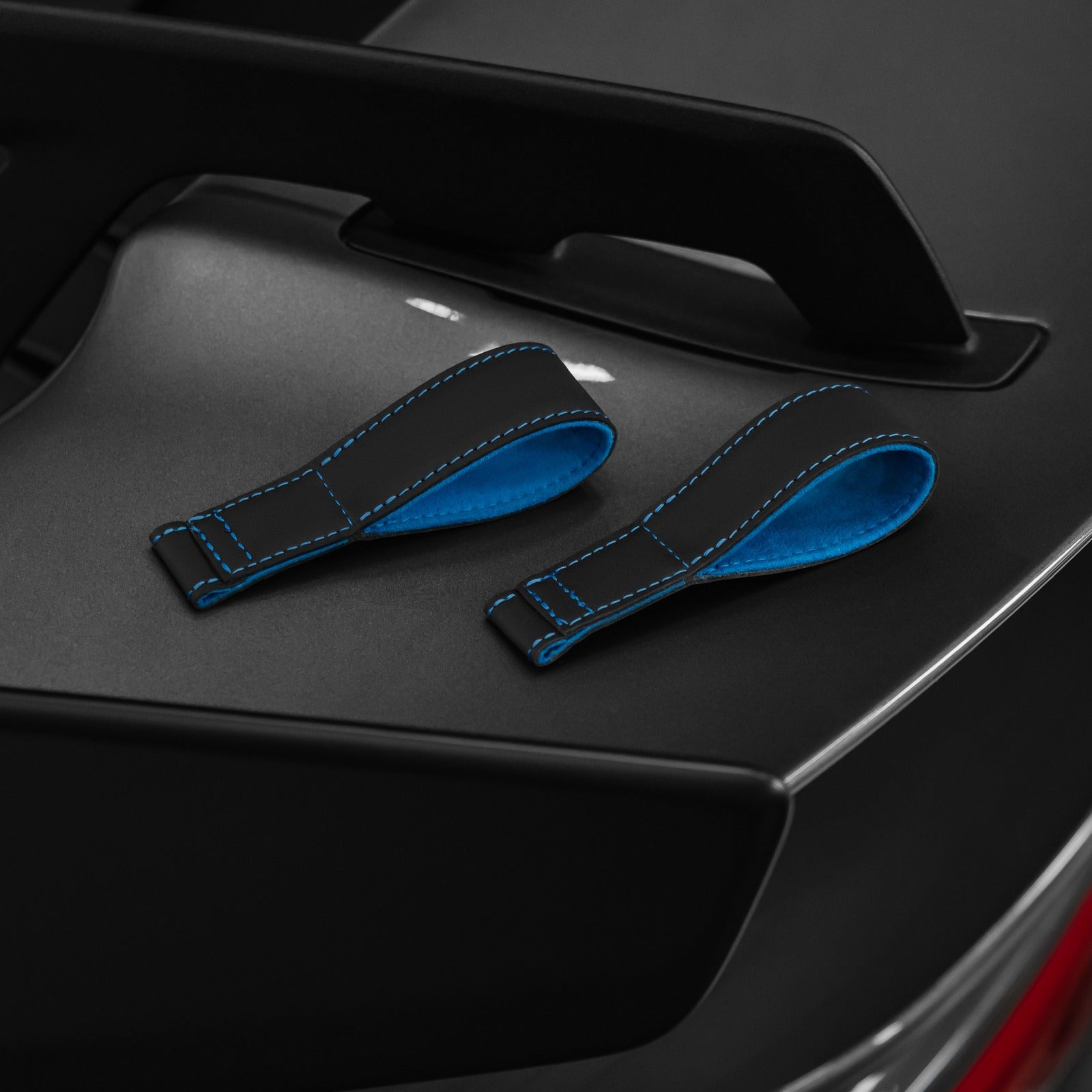 Porsche 992 lightweight door card with blue leather pull straps installed