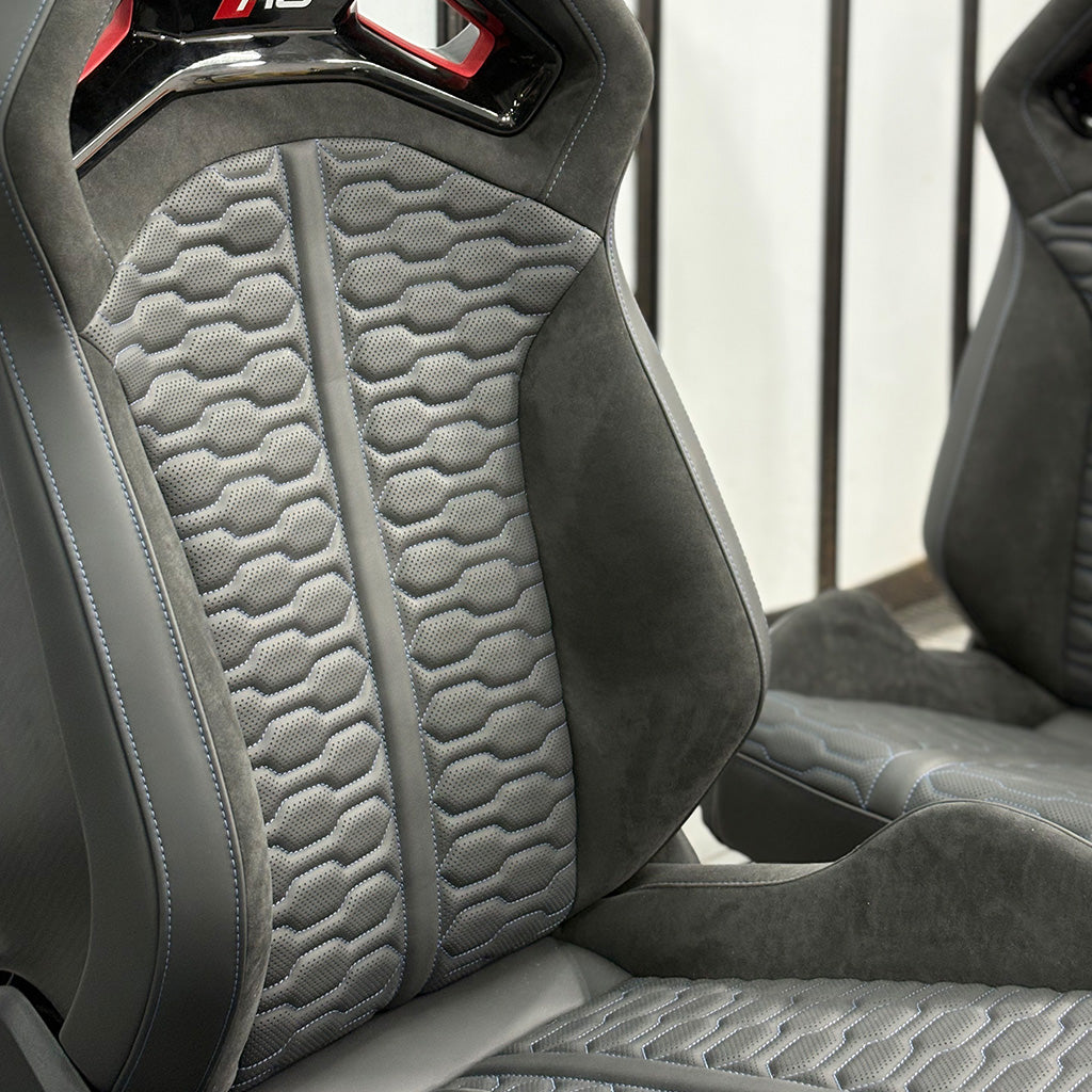 Audi RS bucket seats backrest angle – honeycomb quilted gray Alcantara with RS headrest badge and matching passenger seat