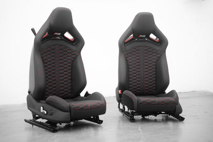Audi R8 folding carbon fiber bucket seats shown as a pair, black leather with red honeycomb stitching and R8 logo headrests, front view
