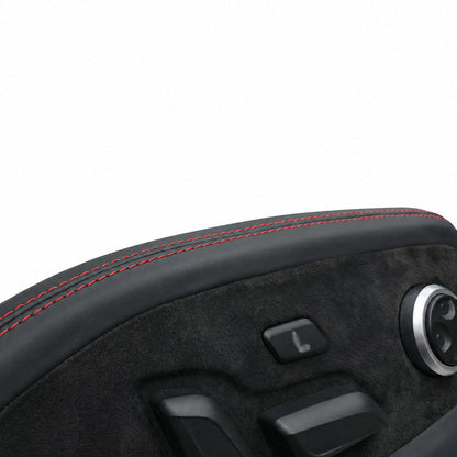Macro detail of red double stitching along the leather edge of an Audi seat side trim panel, Alcantara texture below