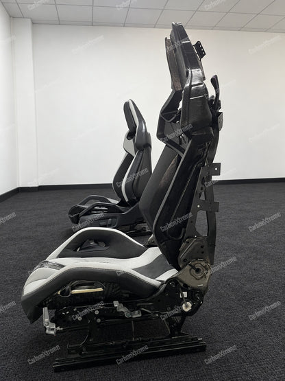 BMW M carbon fiber bucket seat, side profile showing the seat frame, rails and adjustment hardware