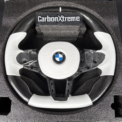 Custom carbon fiber steering wheel for BMW G80 M3, front view with white leather grip, flat top and bottom and white 12 o'clock stripe