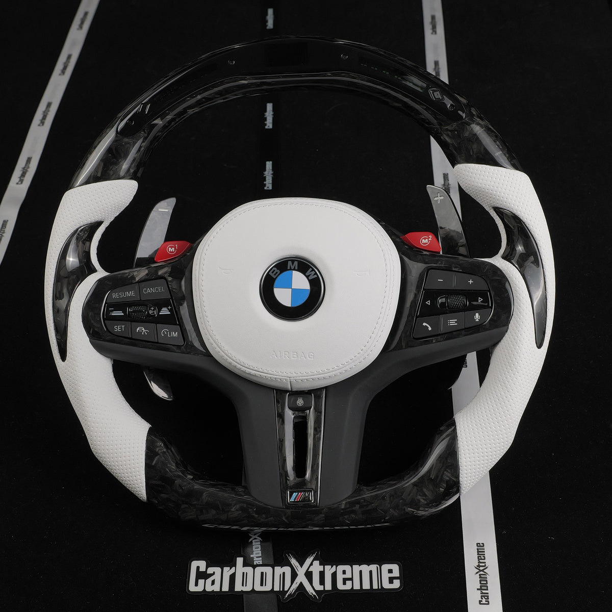Custom forged carbon fiber LED steering wheel for BMW G80 M3, front view with white perforated leather grips and red M1 M2 buttons