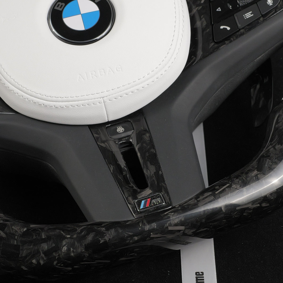 Forged carbon fiber flat bottom section of the custom BMW steering wheel