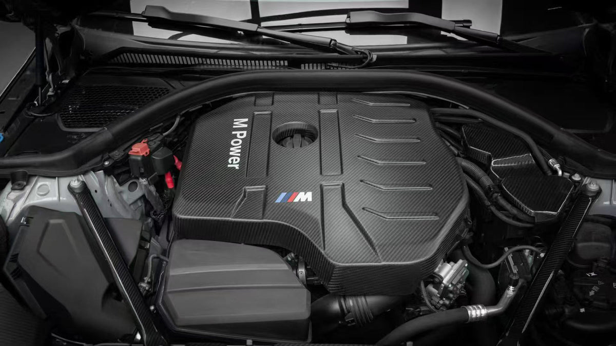 BMW G22 4 Series B48 carbon fiber engine cover is shown installed from the front, with ribs beside the oil cap.