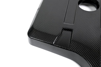 BMW G22 4 Series B48 carbon fiber engine cover is shown close up with its front recess and round oil opening.