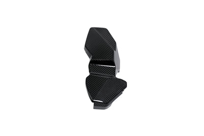 BMW G22 4 Series carbon fiber ECU battery terminal cover is angled on white with its stepped outline visible.