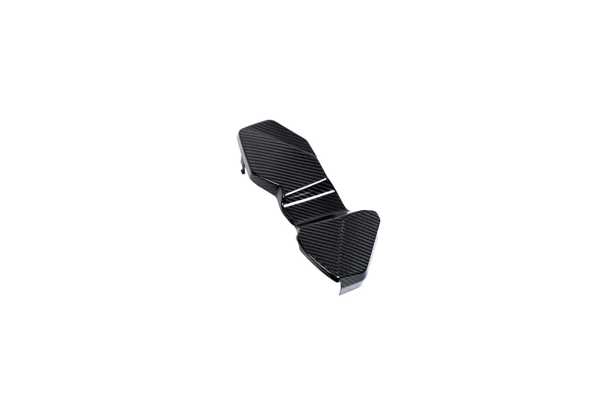 BMW G22 4 Series carbon fiber ECU battery terminal cover is shown diagonally with a narrow central step.