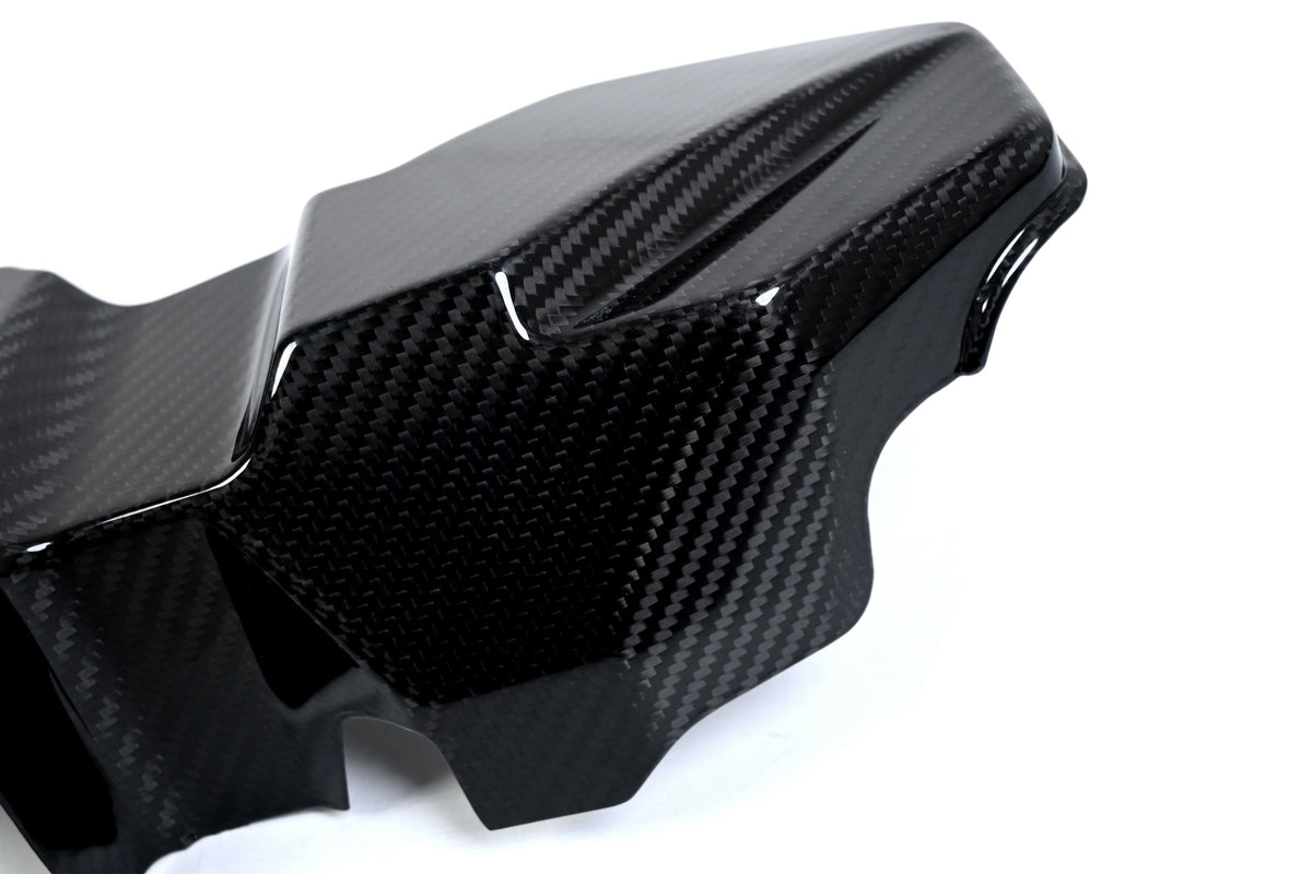 BMW G22 4 Series carbon fiber ECU battery terminal cover is seen close up with a raised end and deep side wall.