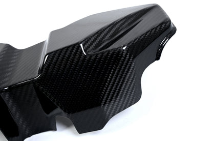 BMW G22 4 Series carbon fiber ECU battery terminal cover is seen close up with a raised end and deep side wall.