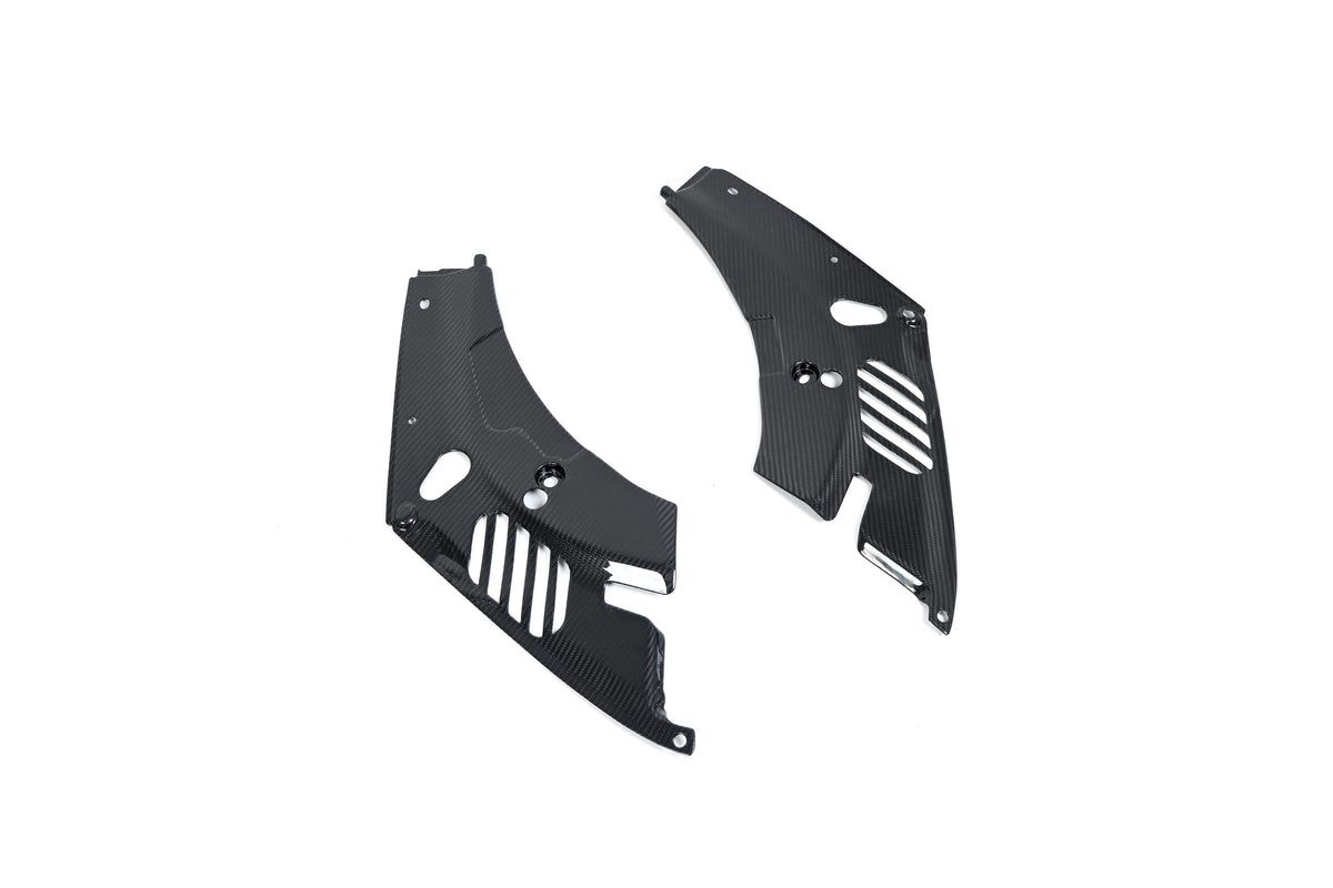 BMW G22 4 Series carbon fiber headlight cover panels are angled on white with slots and mounting holes visible.