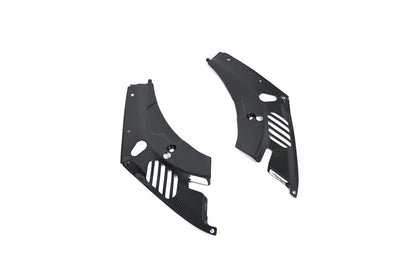 BMW G22 4 Series carbon fiber headlight cover panels are angled on white with slots and mounting holes visible.