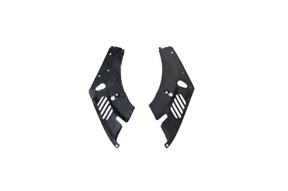 BMW G22 4 Series carbon fiber headlight cover panels are shown on white with one underside facing upward.