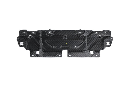 BMW G22 4 Series carbon fiber slam panel cover is shown from the underside with cutouts and mounting tabs.
