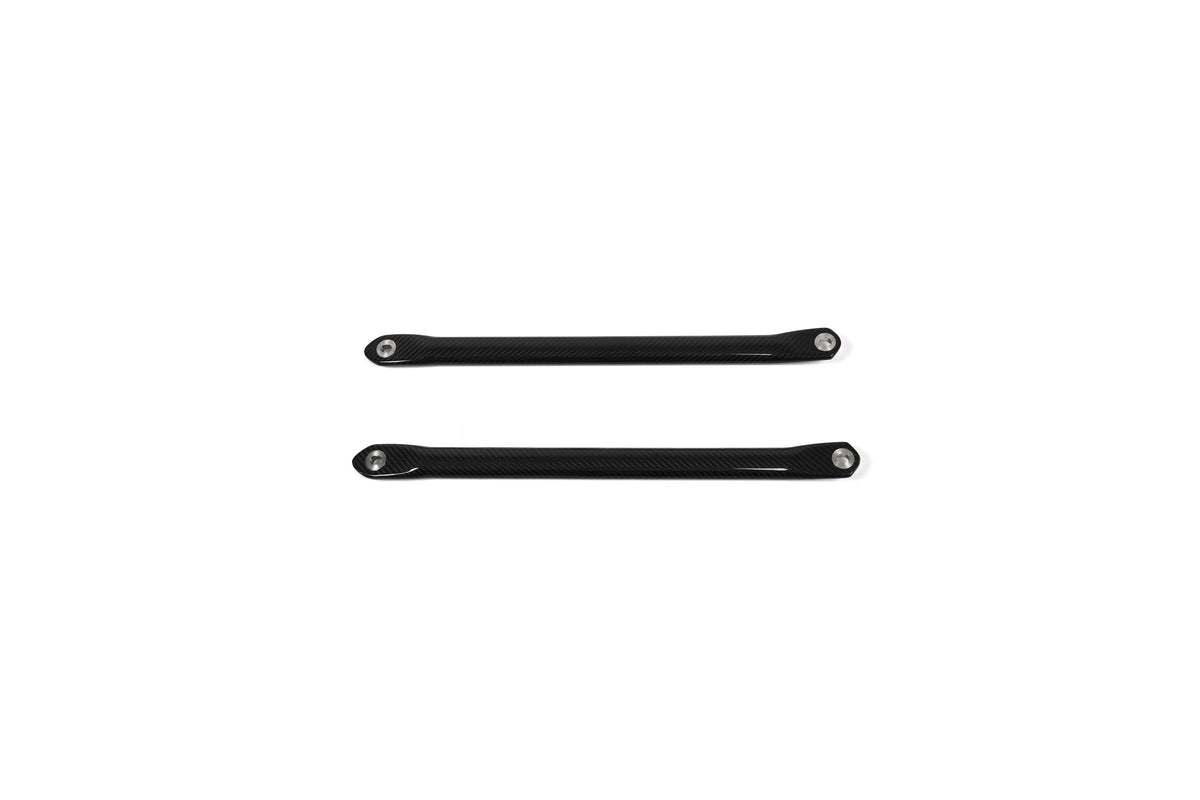 BMW G22 4 Series carbon fiber strut brace bars are shown as a parallel pair with round metal sleeves at each end.