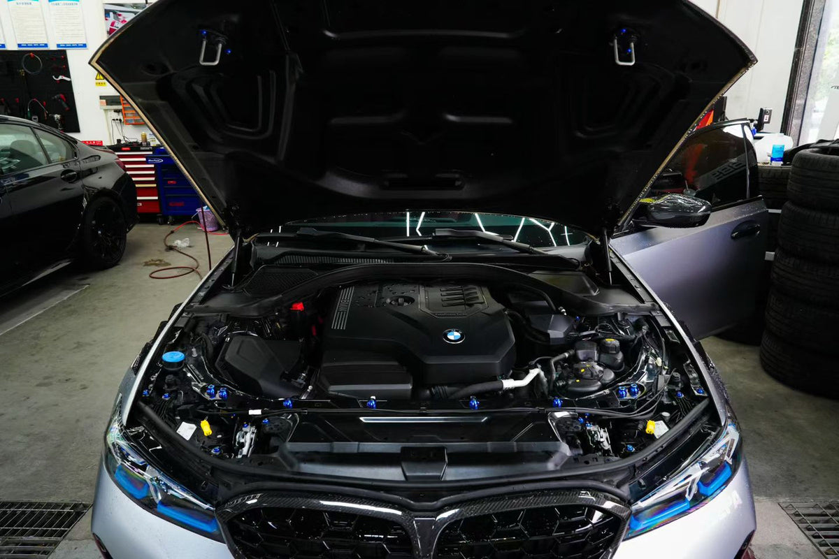 BMW G22 4 Series titanium engine bay bolt kit is shown installed, with blue heads across the open engine bay.