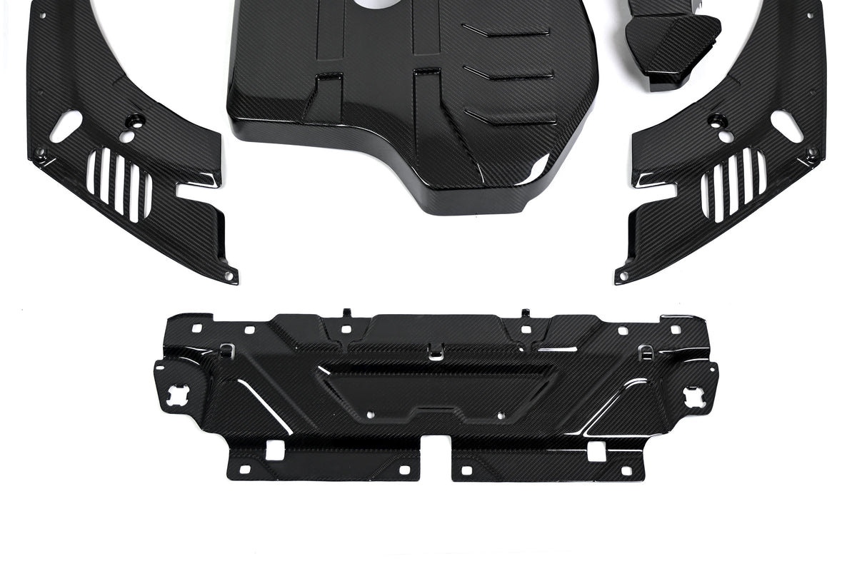 BMW 4 Series engine bay carbon fiber covers are shown close up with the slam panel cover below the slotted panels.