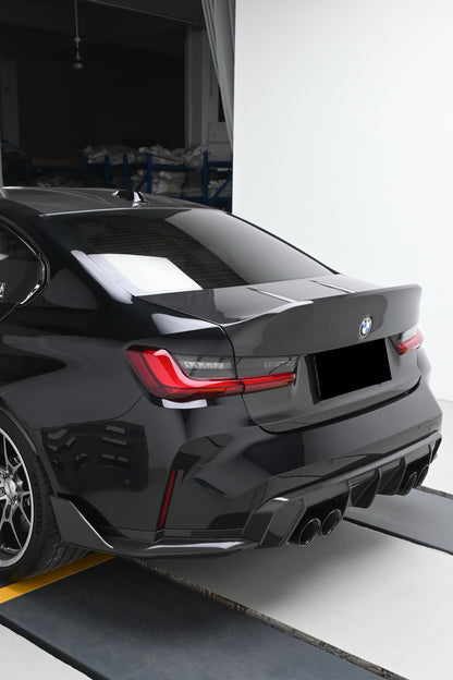 BMW G80 M3 with the CSL style carbon fiber trunk lid installed, rear three-quarter view