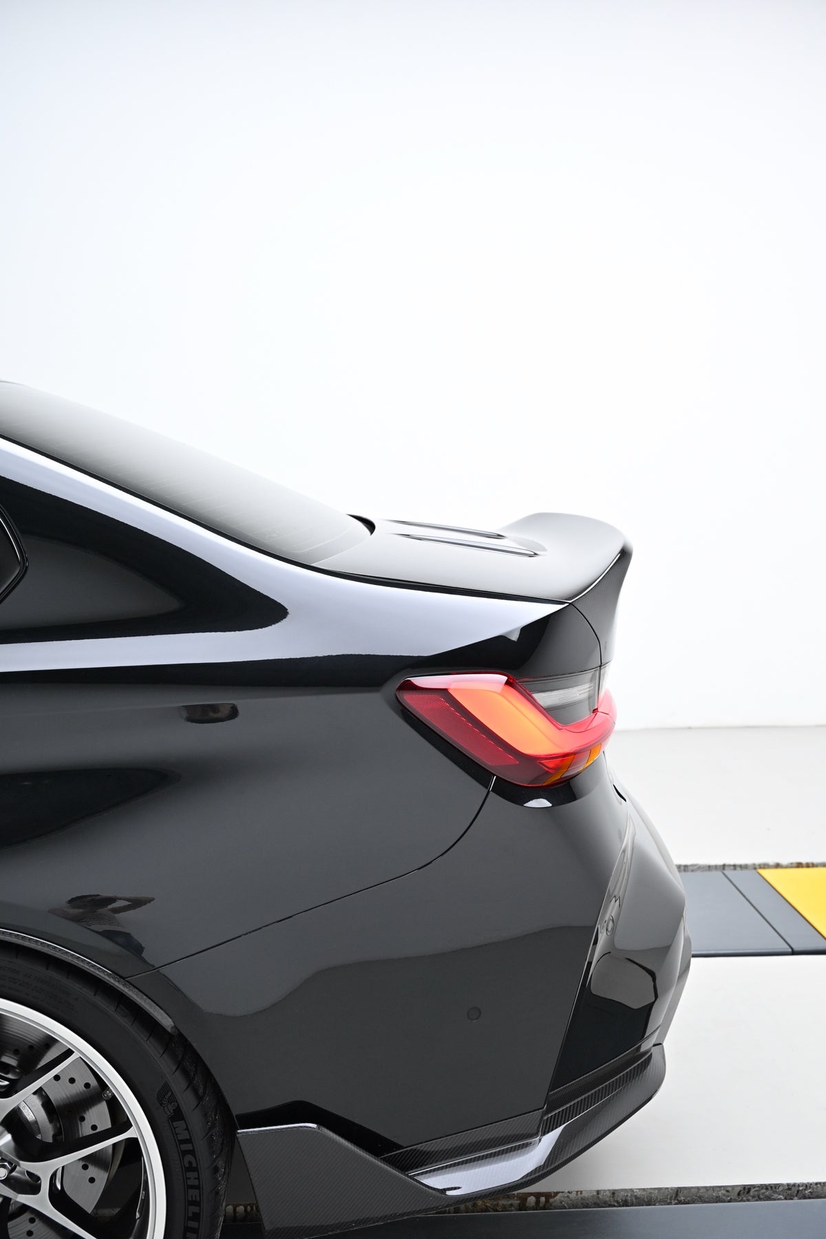 Side profile of the CSL style ducktail on a BMW G80 M3 with the carbon fiber trunk lid installed