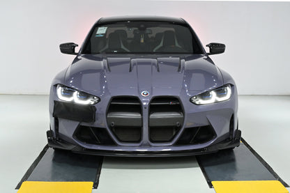 CSL style carbon fiber front lip installed on a BMW G82 M4, front view