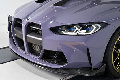 Three-quarter view of a BMW G82 M4 with the CSL style carbon fiber front lip