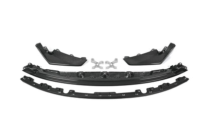 BMW G80 M3 G82 M4 CSL style carbon fiber front lip with corner splitters and metal mounting brackets laid out on white