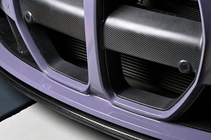 CSL style carbon fiber front lip below the kidney grille of a BMW G82 M4