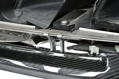 Underside view of the CSL style carbon fiber front lip mounting on a BMW G82 M4