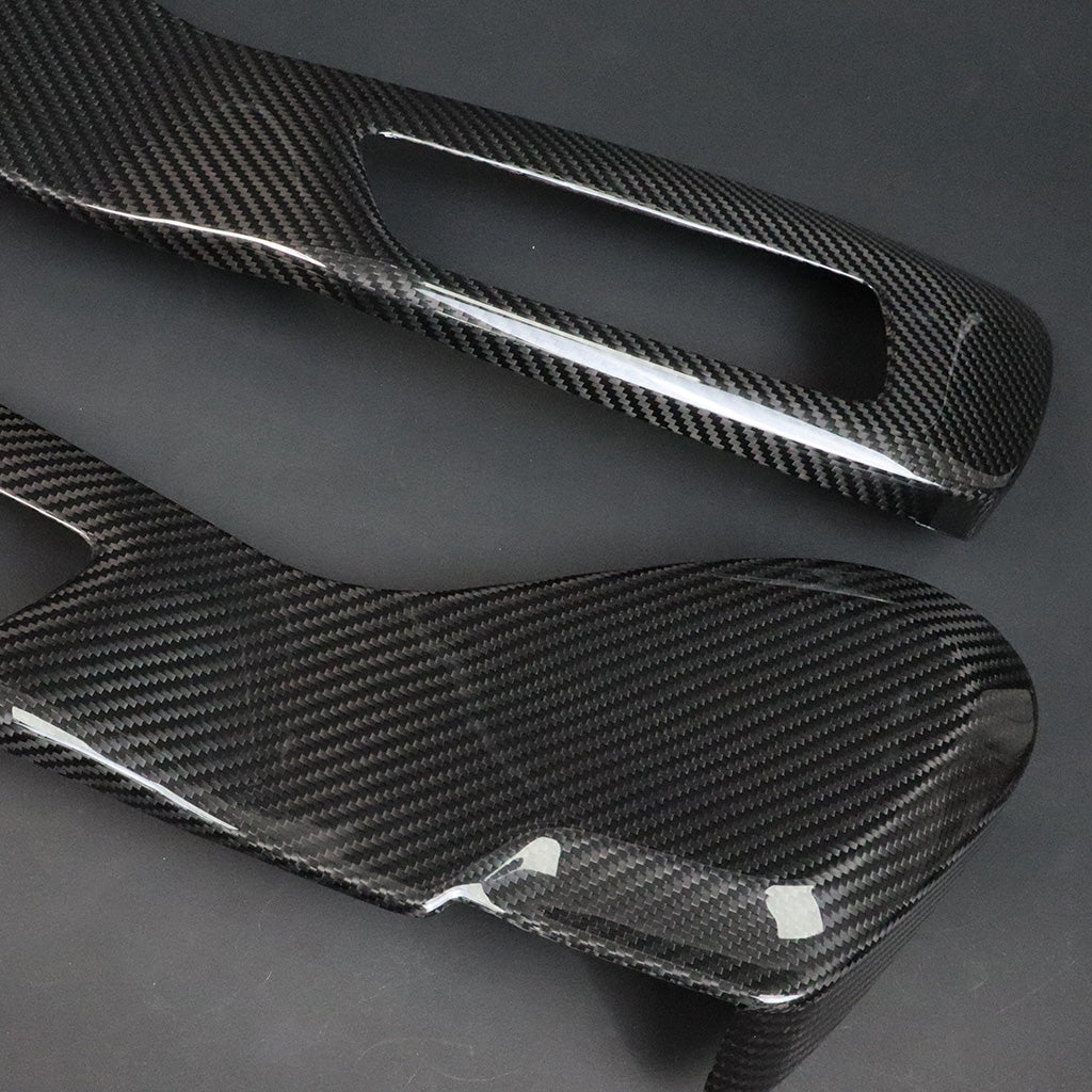 BMW G8X M2 M3 M4 Dry Carbon Side Seat Cover pair – diagonal view, carbon face with protective film and cutout detail visible