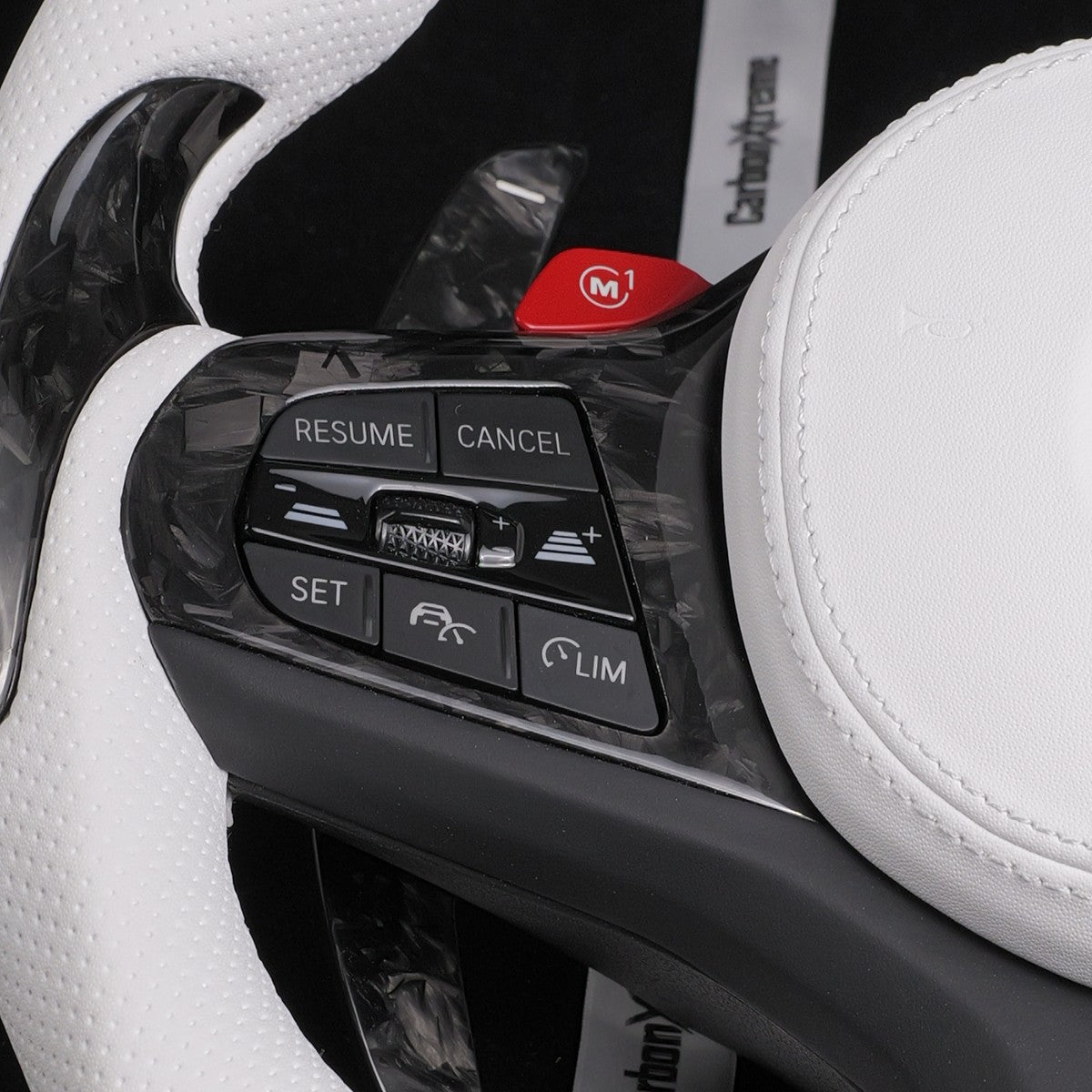 Red M1 button fitted above the cruise control buttons on the left side of the steering wheel