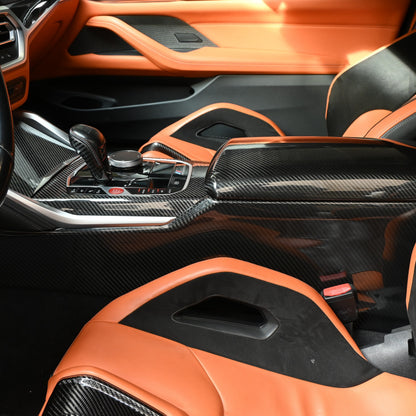 BMW G80 M3 G82 M4 carbon fiber center console side trim and armrest cover installed, gloss carbon weave with orange leather interior