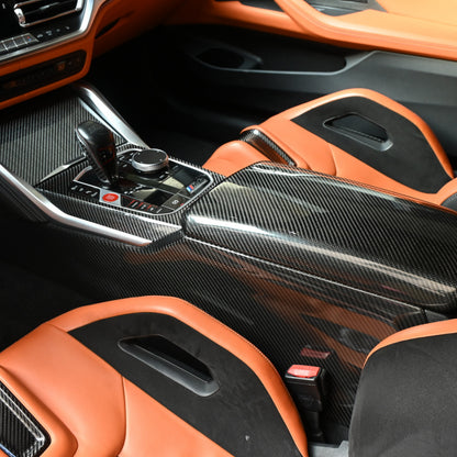 BMW M3 M4 carbon fiber console side trims installed along the center console, cabin wide view