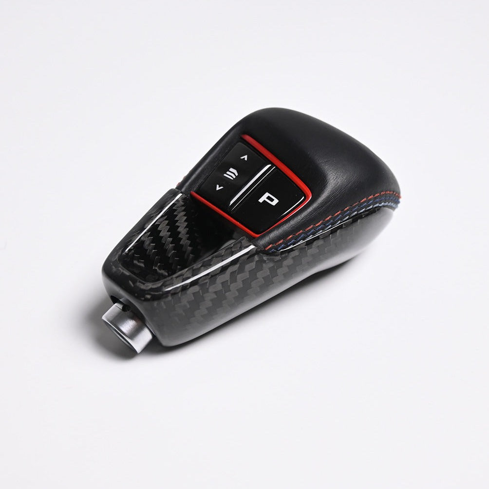 BMW M3 M4 M2 carbon fiber gear selector cover fitted on the gear selector with shift buttons exposed