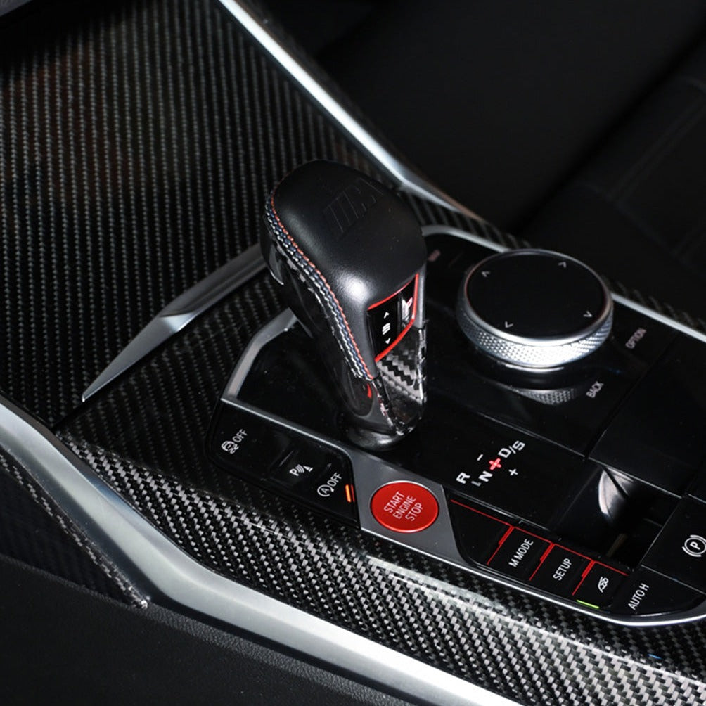 BMW M3 M4 carbon fiber gear selector cover installed, center console view with M controls