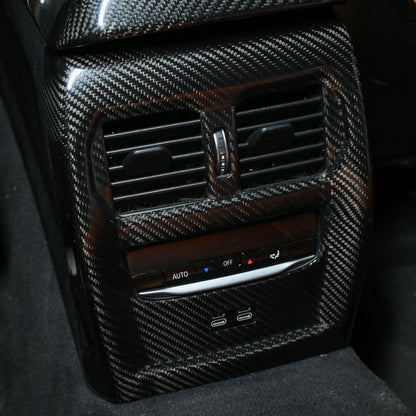 BMW M3 M4 carbon fiber rear vent trim installed, close up with USB C ports below the vents