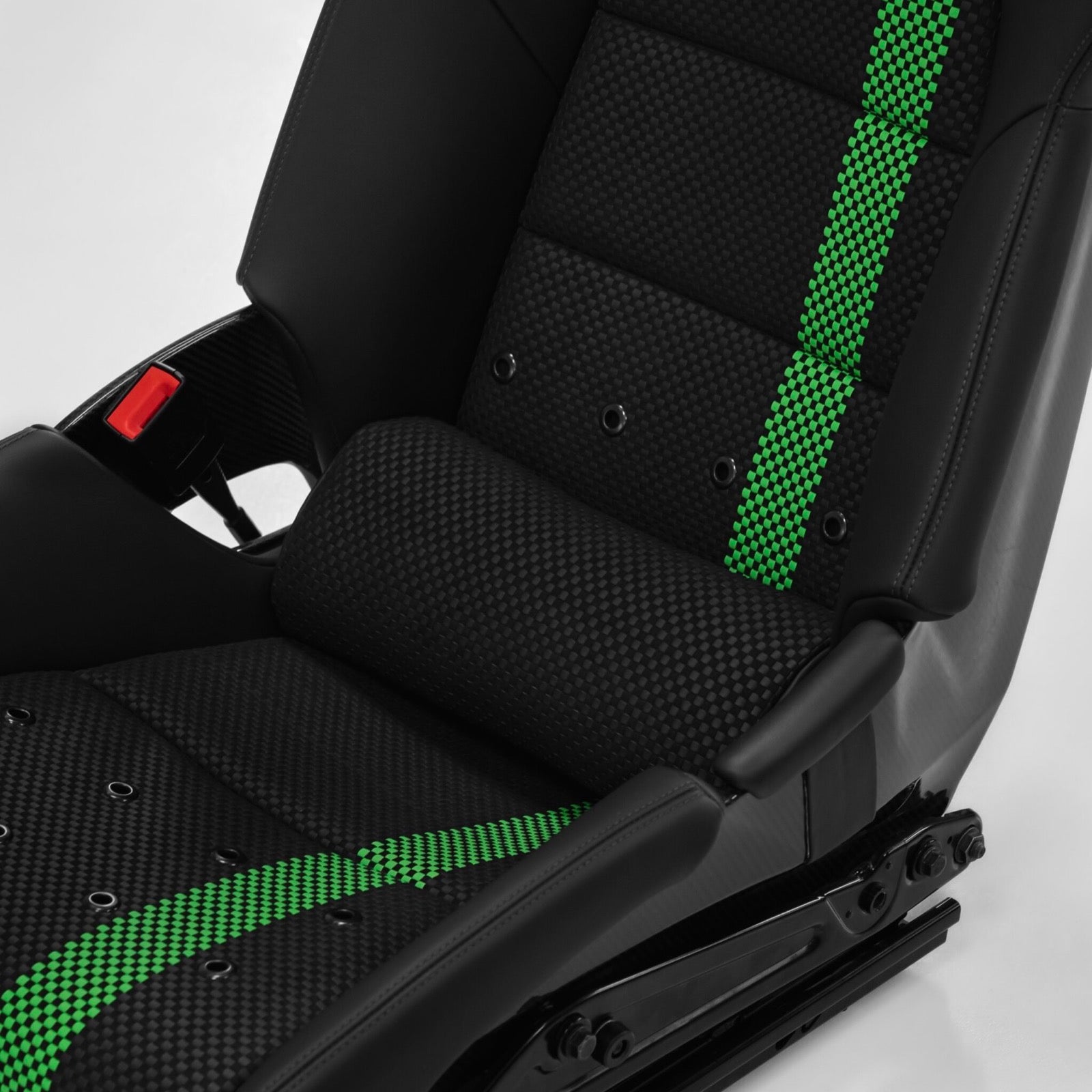 Porsche 918 style carbon bucket seat with a black lumbar support pillow installed low in the seat back, green and black carbon weave visible