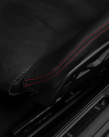 Detail of Porsche 992.2 folding bucket seat bolster protector, perforated black leather red stitching
