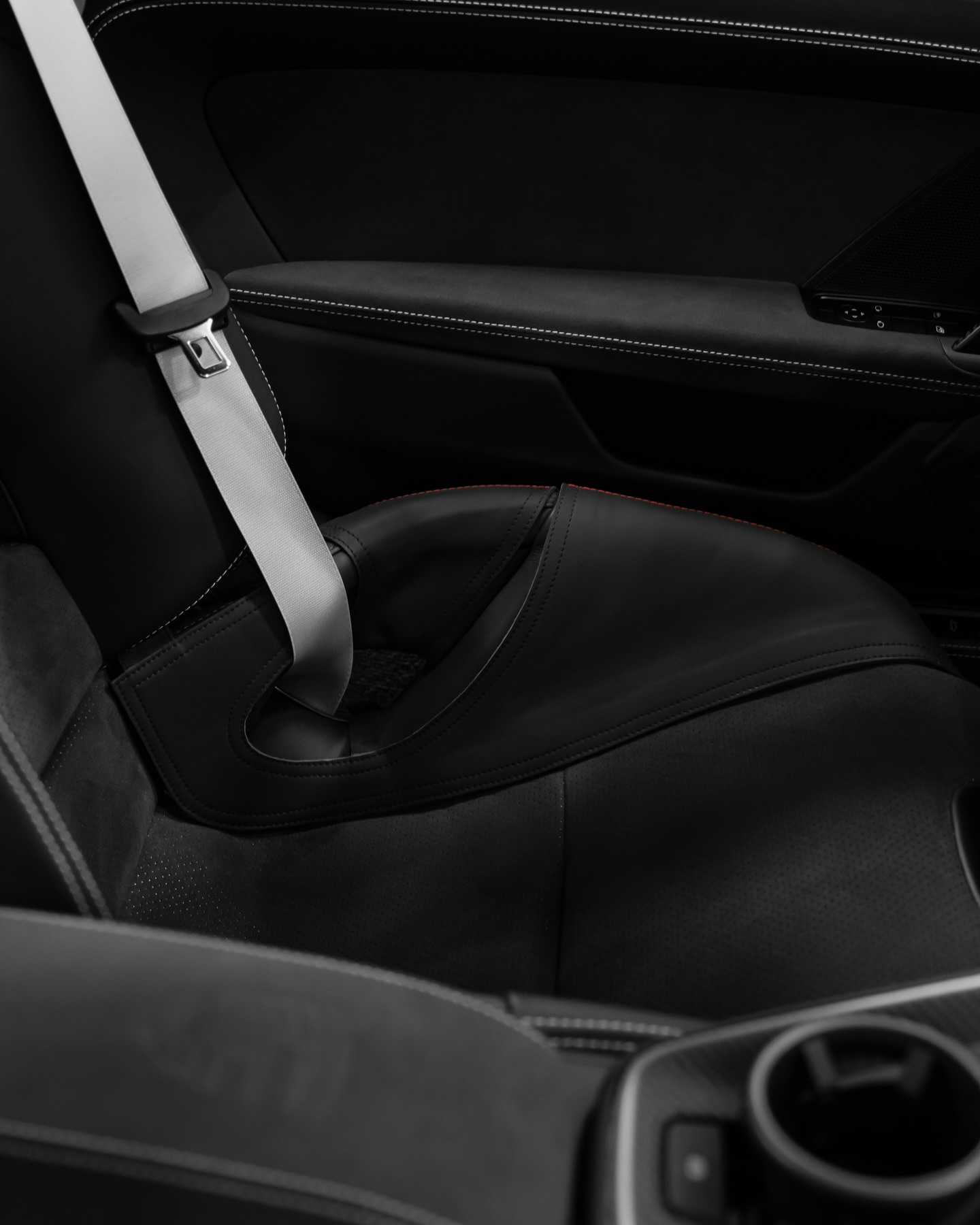 Porsche 992.2 GT3 carbon bucket seat with black bolster protector and seatbelt, interior view