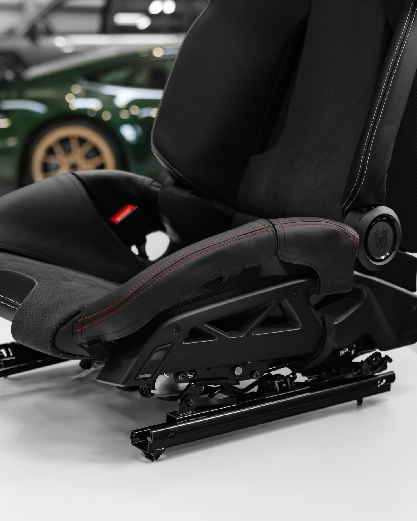 Porsche 992.2 GT3 carbon folding bucket seat with bolster protector, side view showing folding base