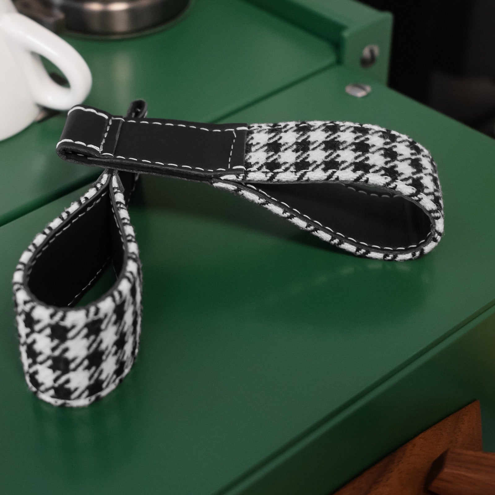 Porsche 992 houndstooth fabric door pull strap detail with black leather trim