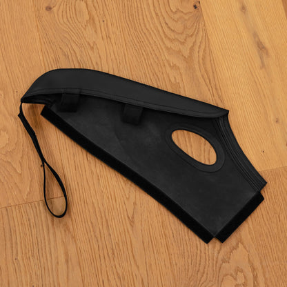 Porsche 997 bucket seat bolster protector laid flat showing the soft underside, fastening strip and belt opening