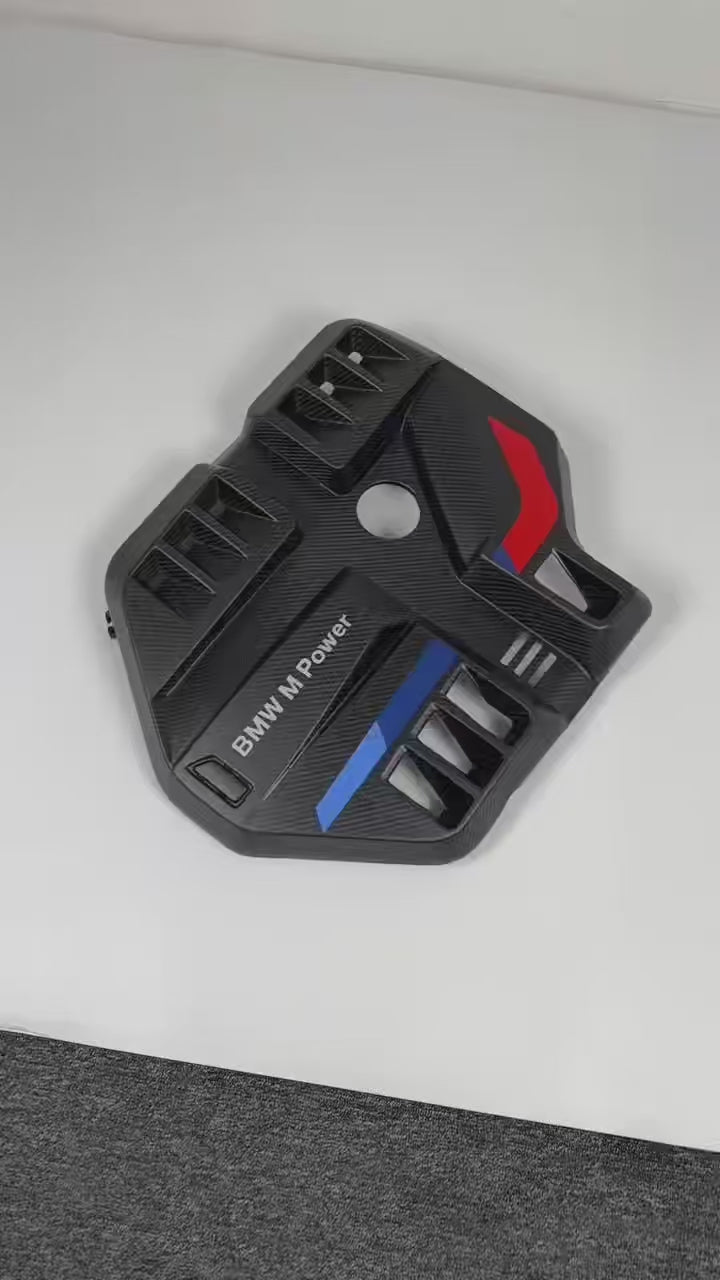 Load video: BMW G8X M2 M3 M4 S58 dry carbon fiber engine cover with MP tricolor strip by CarbonXtreme
